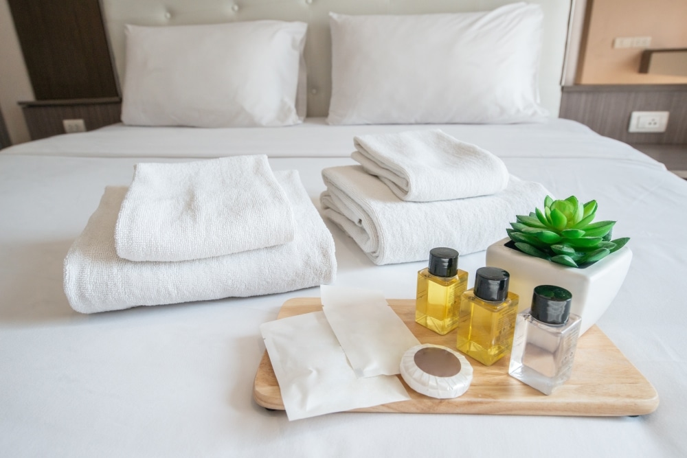 neatly made bed with shampoos and other amenities in aruba