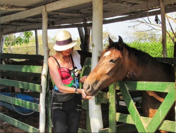 woman getting ready for luxury horseback riding as part of her travel package in colombia