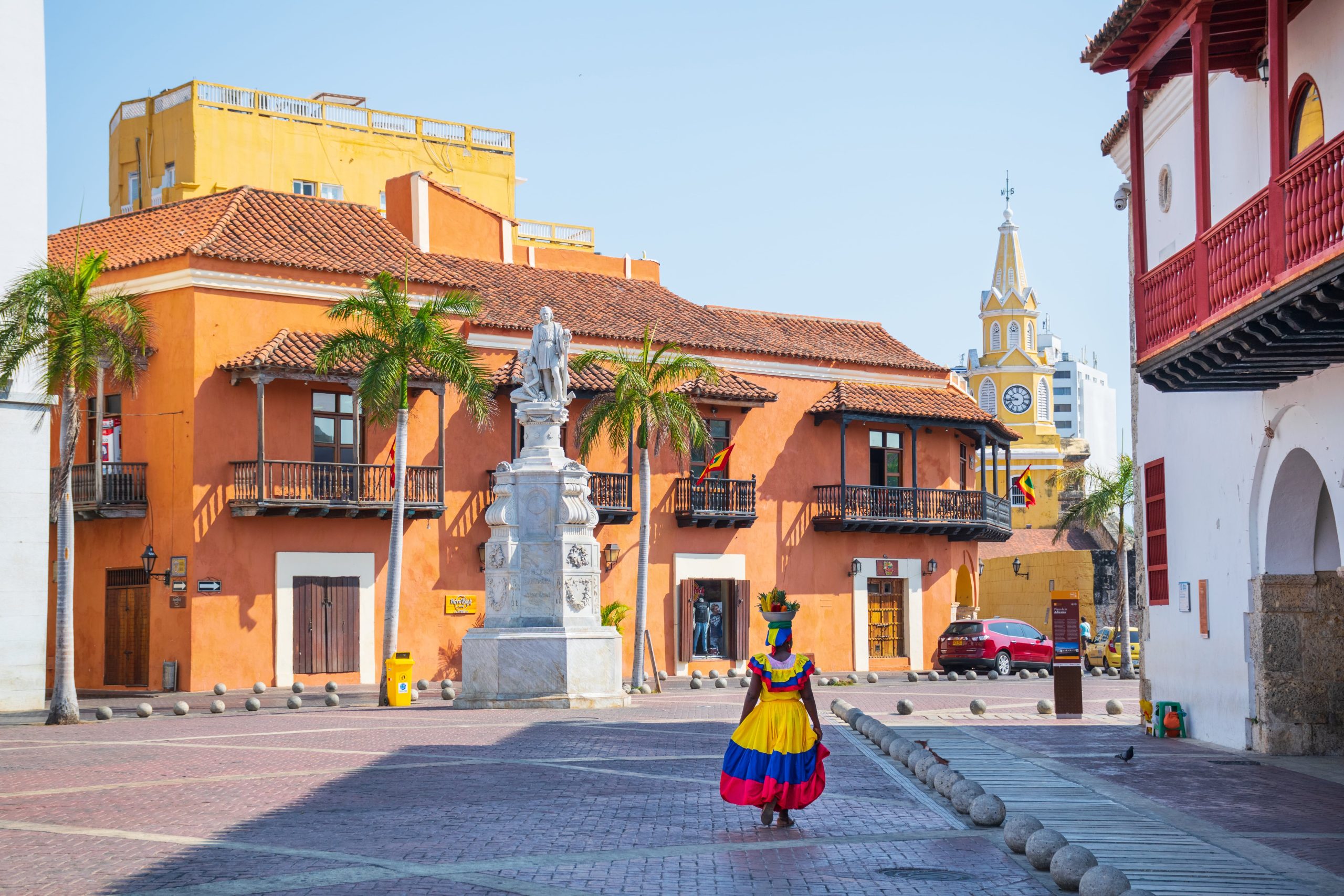 Traditional woman walking through the street of colonial colombian city